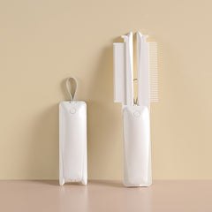 White folding pet grooming and hair-removal tool